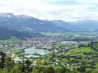 Scenic Salzburg landscape with hills, lakes, and Alps.