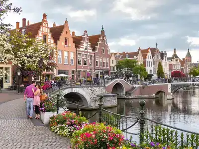 Couple walking along a canal in Bruges.