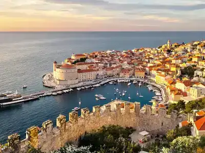  Couples and families enjoying Dubrovnik's beautiful streets at sunset.