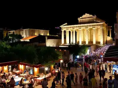 Nightlife in Pula with cafes and ancient ruins visible.