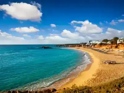  Sandy beach, with blue sea and sun beds, Cyprus.