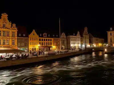 Nightlife in České Budějovice with illuminated buildings and cafes.