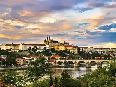 Prague skyline with Charles Bridge and sunset sky.