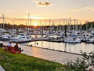 Couples and families enjoying Munkebo Marina at sunset.