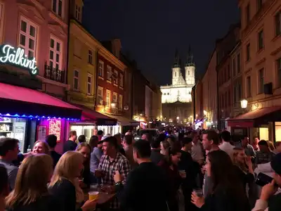 People enjoying nightlife in vibrant Prague streets at night.