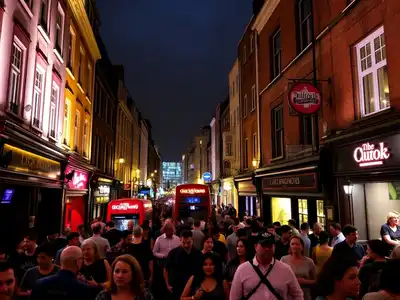 Vibrant London nightlife with crowds and illuminated pubs.