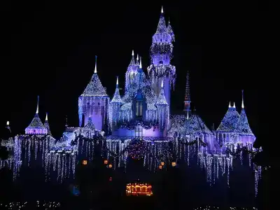 Disneyland Paris lit up against a night time sky