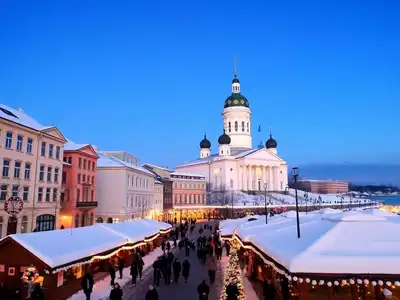 Snowy Helsinki Cathedral with holiday lights in December.