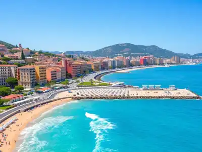 Coastal view of Nice with beach and colorful buildings.