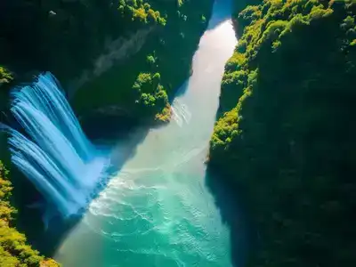 Aerial view of a majestic waterfall in lush greenery