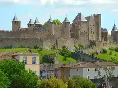 Carcassonne castle fortress viewed from below with a clear blue sky backdrop.