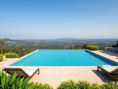 Infinity pool with scenic French landscape in the background.