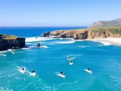 Surfers riding waves in the Basque Country, France.