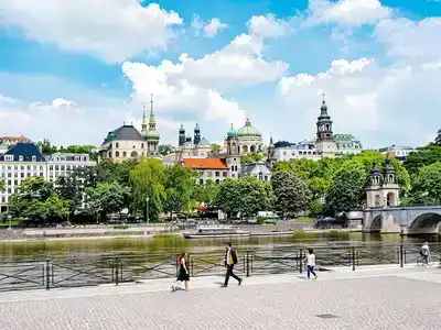 Couples walking along the scenic riverbank in Berlin.