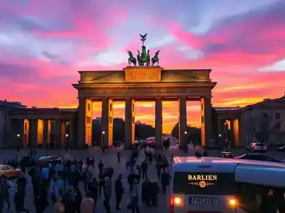 Brandenburg Gate in Berlin at sunset with crowds.