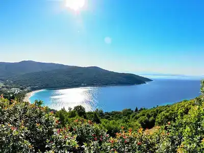 Lush landscapes of Corfu with clear blue skies.