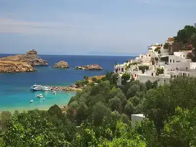 Rhodes sea overlooked by hillside white walled village