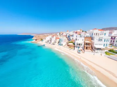 Aerial view of Mykonos with blue waters and white buildings.