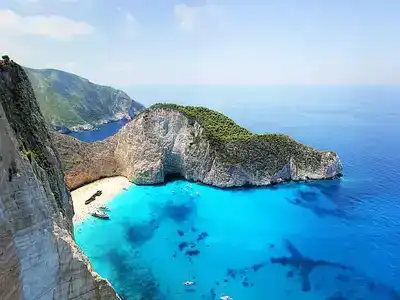  Crowded Zakynthos beach with clear blue sky.