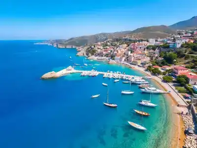 Aerial view of Greece's coastline with boats and villages