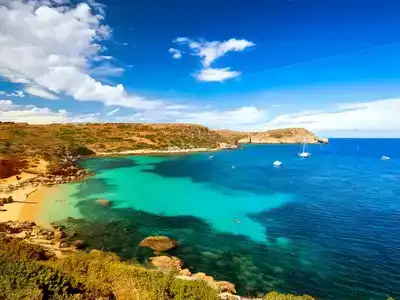 Ghajn Tuffieha Bay under a clear blue sky