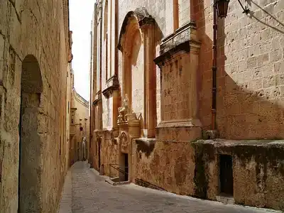 narrow alleyway lined with old stone buildings