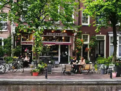 Couples enjoy coffee by Amsterdam’s scenic canals.