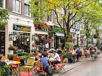 Outdoor dining in Amsterdam with food and drinks.