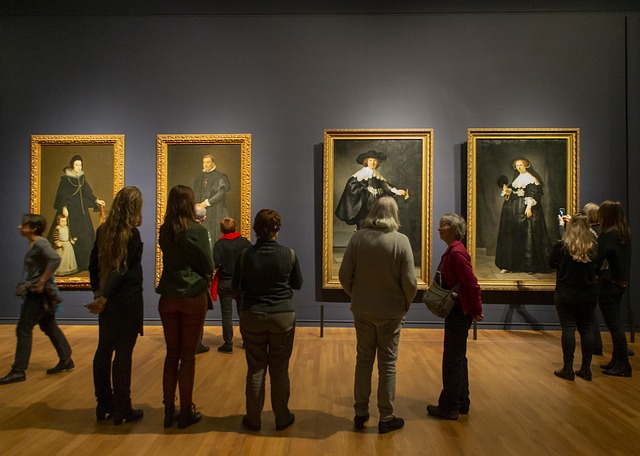 Group of people looking at four paintings in the Rijksmuseum, Amsterdam