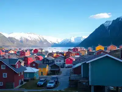 Colorful houses in Tromsø with mountains in background.