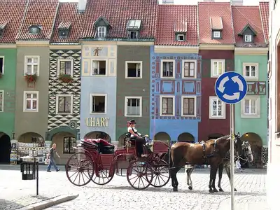 Horse drawn carriage travelling through the market square, Poznań, Poland