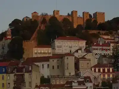 Hillside with houses and a castle at the top