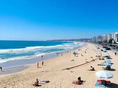 Surfers and sunbathers at Playa de la Victoria, Cádiz.