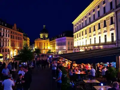 Colorful nightlife in Geneva with lively streets and cafes.