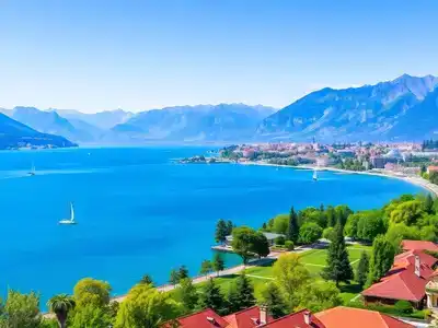 Scenic view of Lake Geneva with mountains and boats.