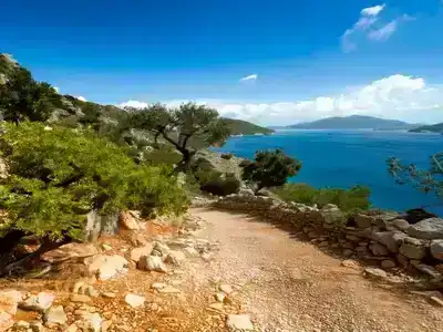 Footpath of the Lycian Way running alongside a deep blue sea