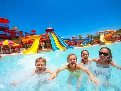 Families enjoying water slides in a Turkish water park.